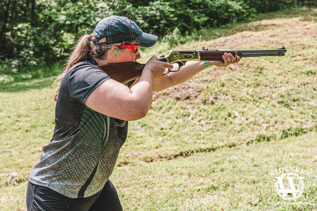 a photo of a woman shooting a henry 30-30 lever action rifle 