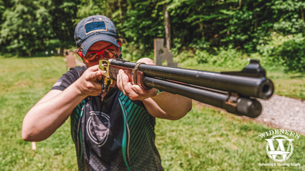 a photo of a woman shooting a lever action rifle