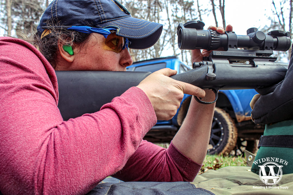 a photo of a woman shooting a Remington 700 SPS Tactical rifle