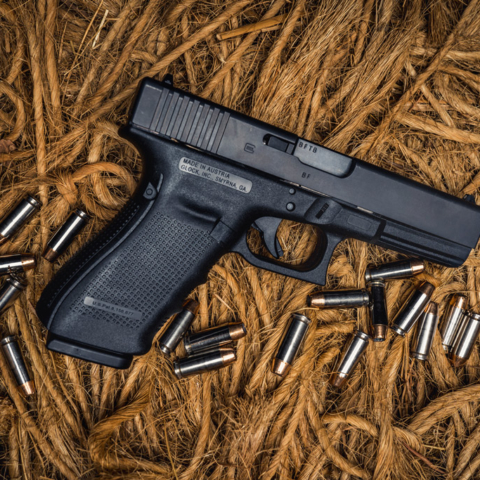 photo of glock 20 10mm pistol on ropes