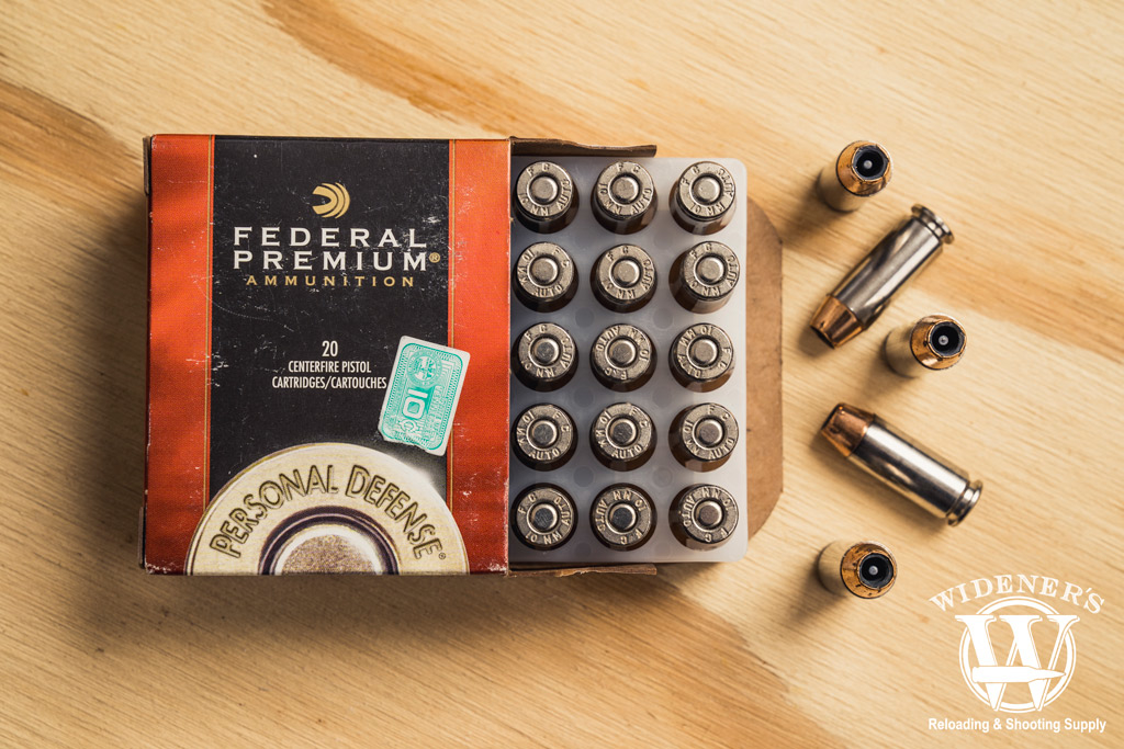photo of federal premium 10mm ammo on a sheet of plywood