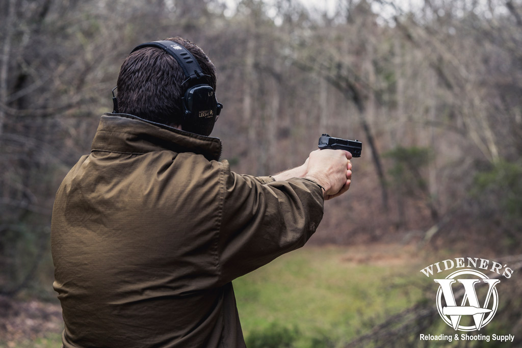 photo of a man shooting a smith & wesson handgun