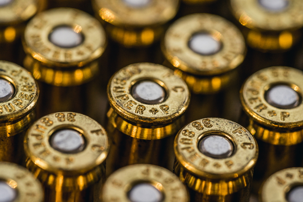 a macro photo of plus p ammo cartridges