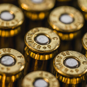 a macro photo of plus p ammo cartridges