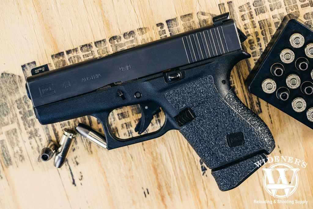 a photo of a glock 43 handgun with 9mm ammo