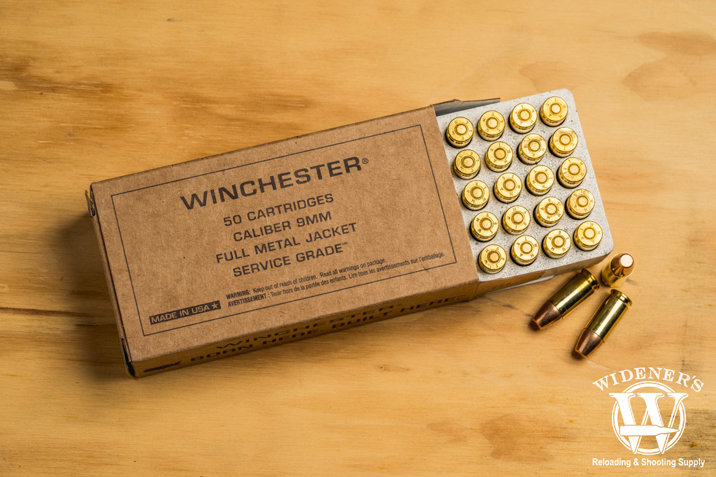 photo of winchester service grade 115gr practice ammo on a sheet of plywood