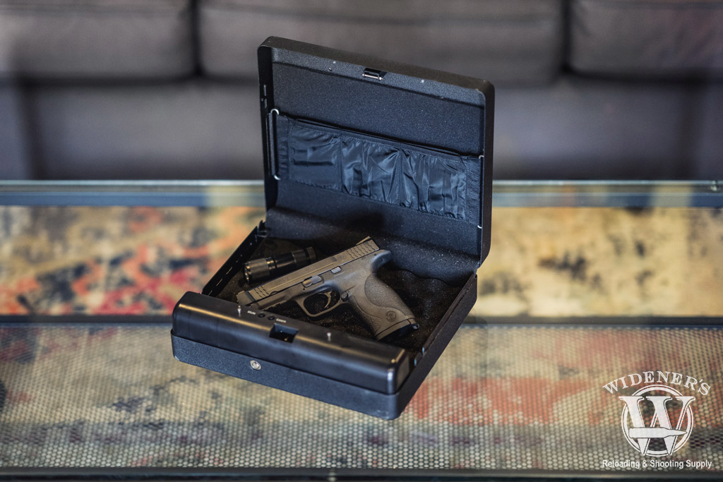 a photo of a smith and wesson pistol sitting in a safe used as the best home defense
