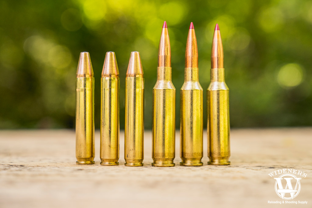 A photo of 350 legend ammo compared to 6.5 creedmoor ammo outdoors