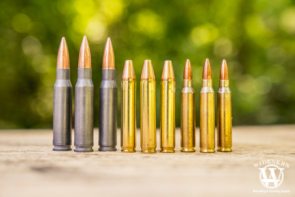 a photo of 7.62x30 ammo compared to 350 legend ammo compared to 5.56 ammo outdoors