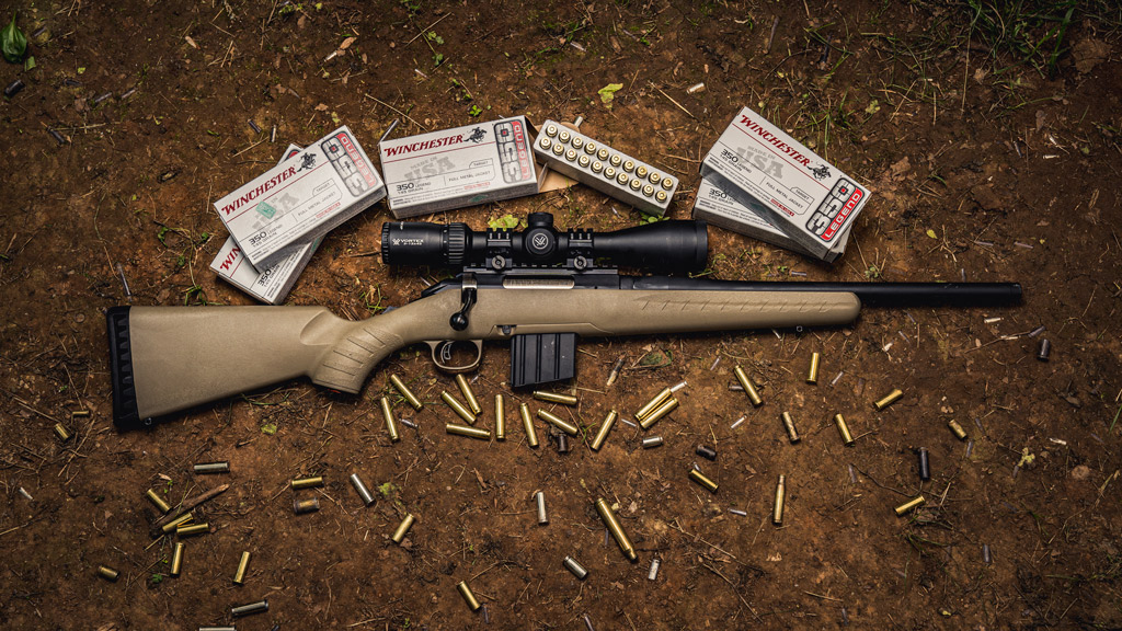 photo of the ruger american ranch rifle next to winchester 350 legend ammo
