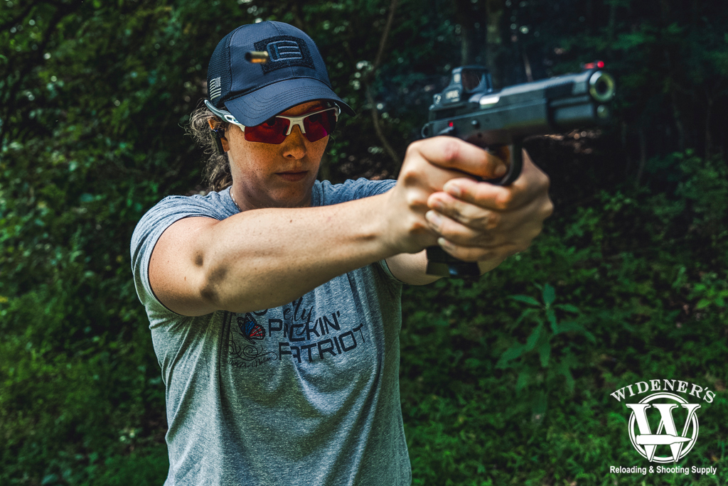 a photo of a woman shooting a handgun at the range