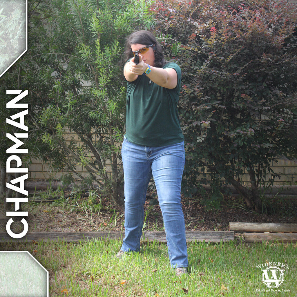 a photo of a female instructor demonstrating chapman pistol shooting stances