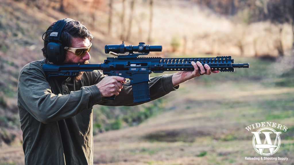 man shooting an ar-10 rifle a photo of a man shooting an ar-10 rifle