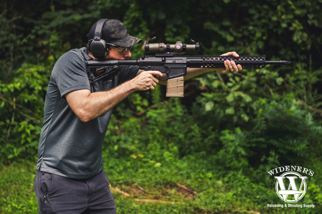a photo of a man shooting a rifle with an LPVO optic