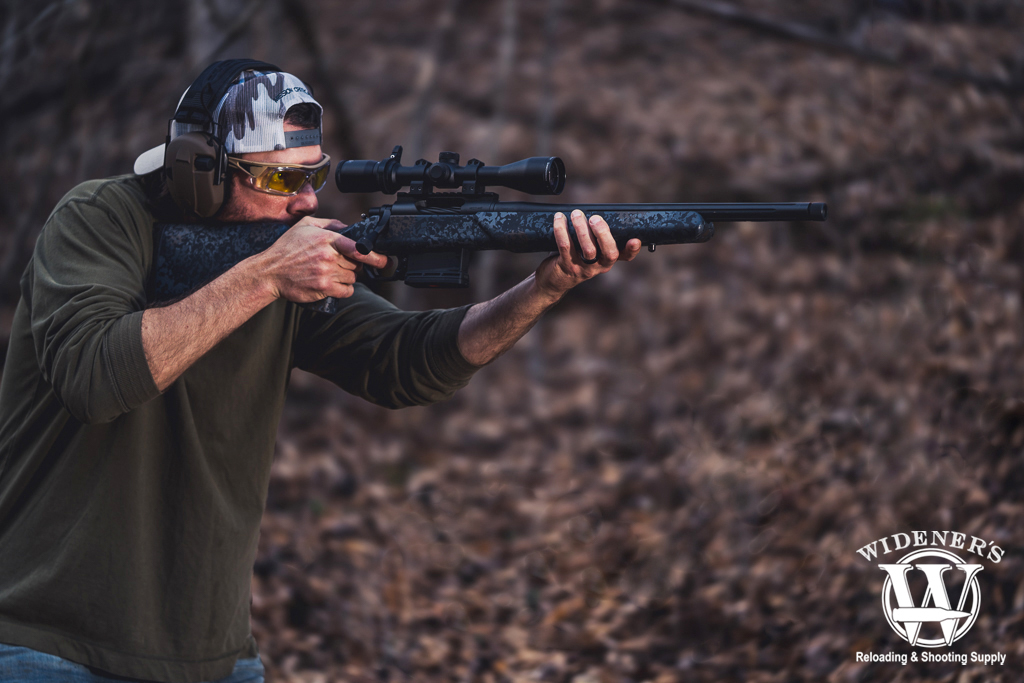 man shooting a bolt action rifle a photo of a man shooting a bolt action rifle