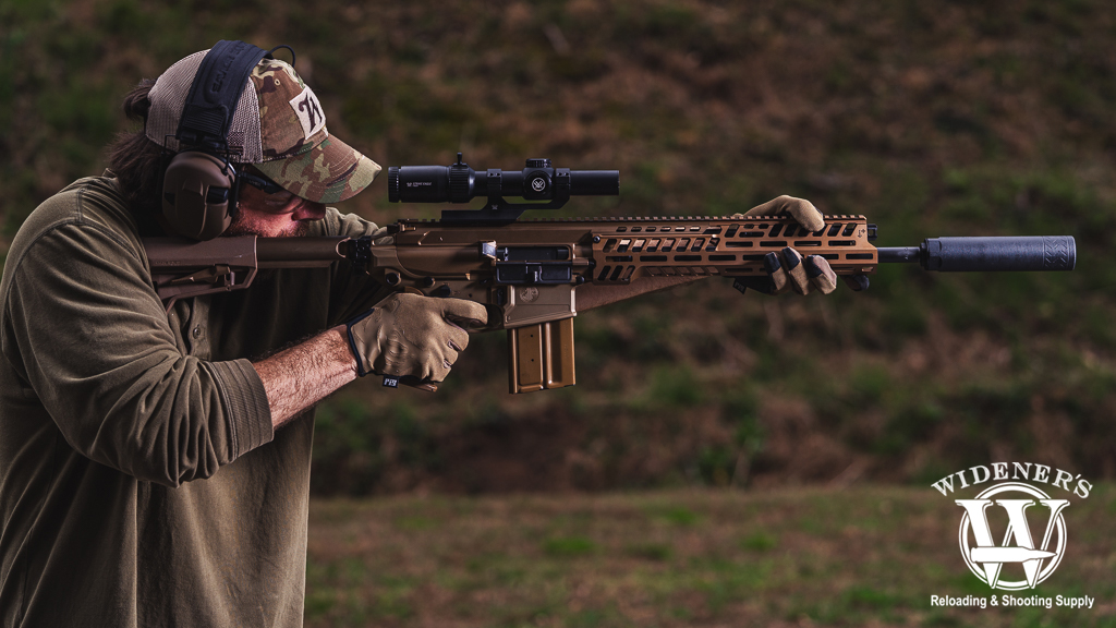 a man shooting a MCX Spear rifle a photo of a man shooting a MCX Spear rifle