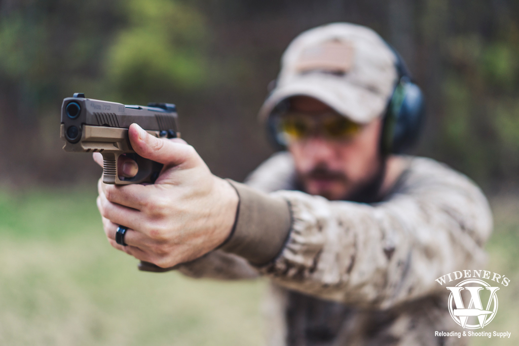a photo of a man shooting a handgun