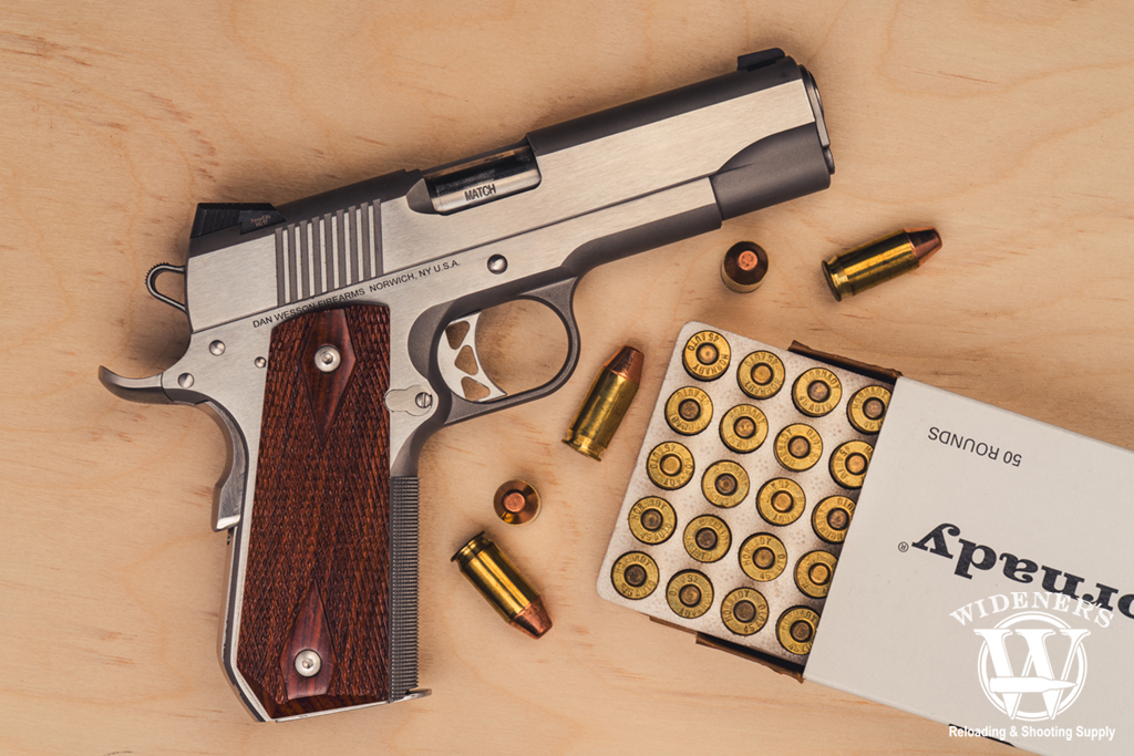 1911 style pistol with 45 acp ammo a photo of a 1911 style pistol with 45 acp ammo