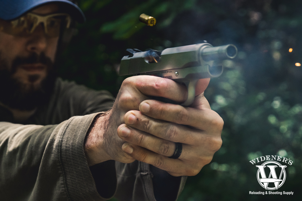 man shooting a 45 acp handgun outdoors a photo of a man shooting a 45 acp handgun outdoors
