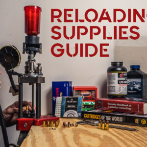 a photo of a man using a reloading press in a workshop
