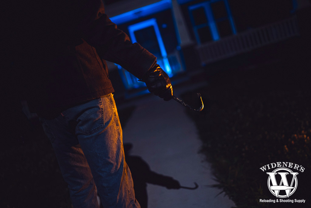 a photo of a man breaking into a home
