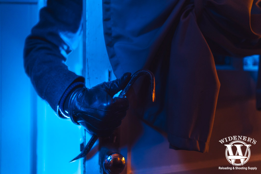 a photo of a burglar breaking into a home 