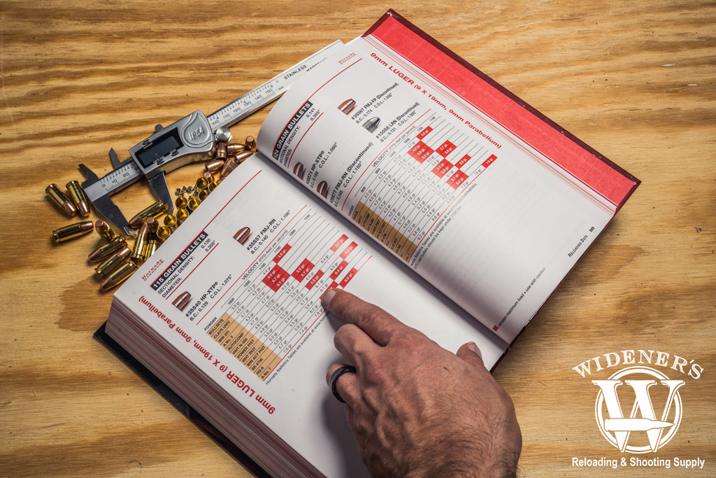 a photo of a man reading the hornady handbook of cartridge reloading