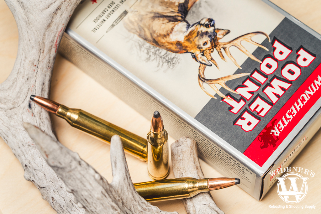 a photo of centerfire rifle ammo with a deer antler