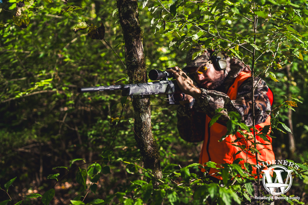 a photo of a man shooting a deer hunting rifle