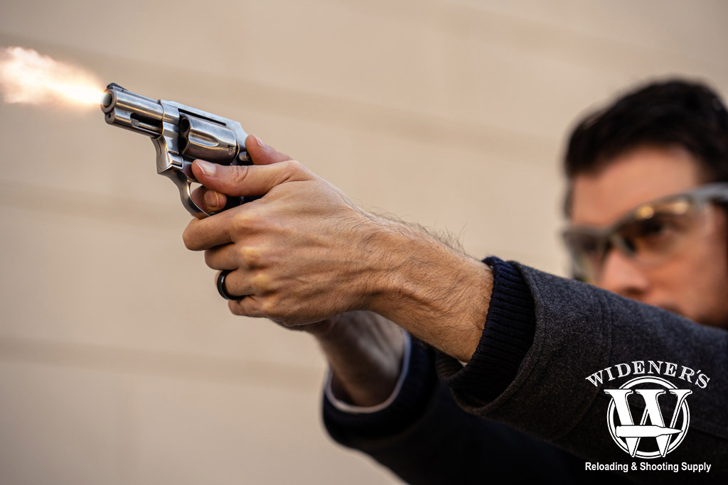 a photo of a man shooting a silver revolver