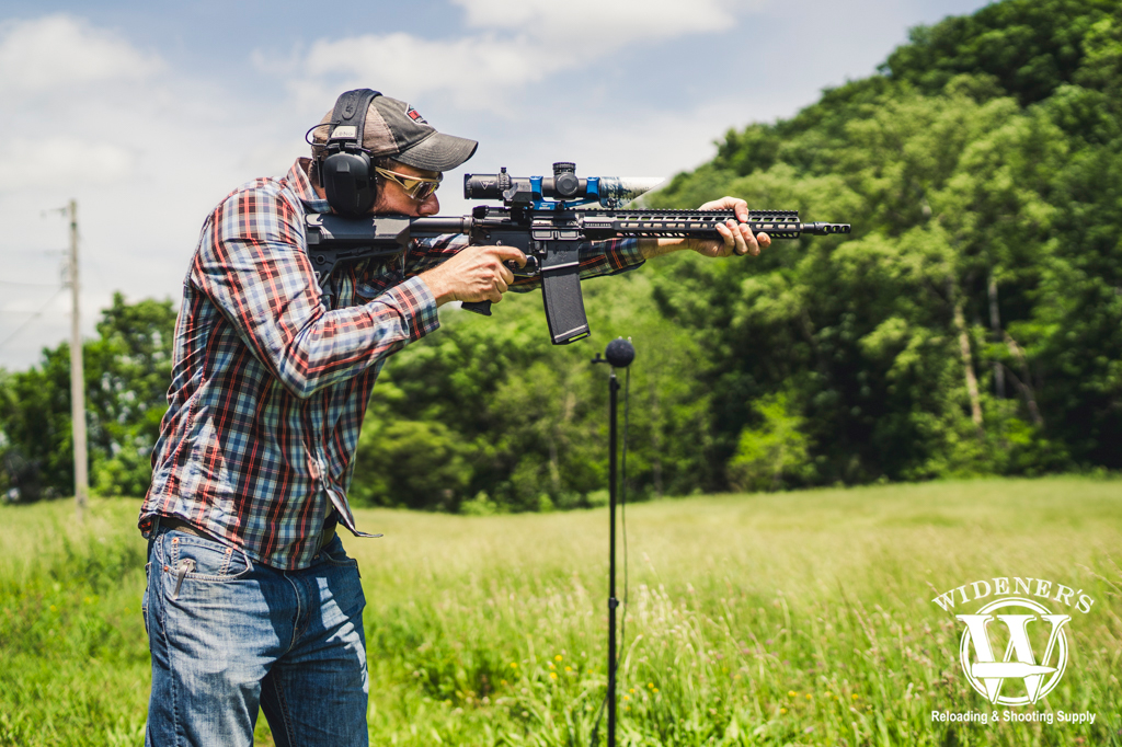 a photo depicting how loud is a gunshot with a man shooting an ar-15 rifle