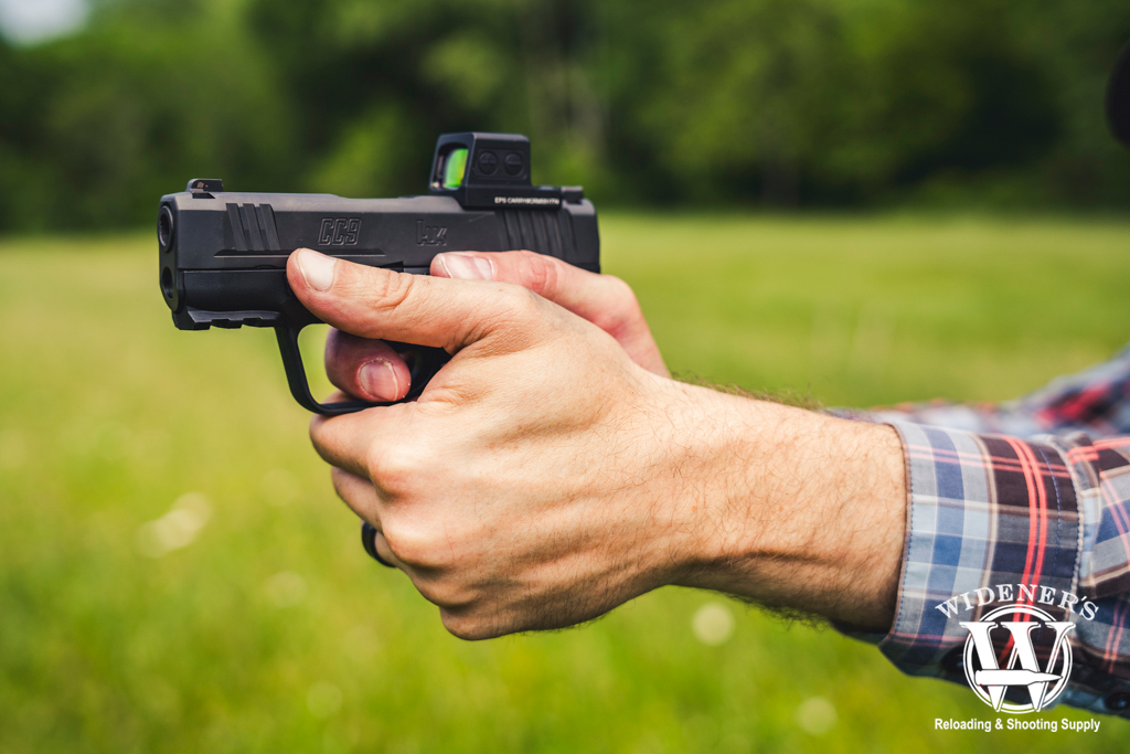 a photo of a man shooting an H&K CC9 pistol