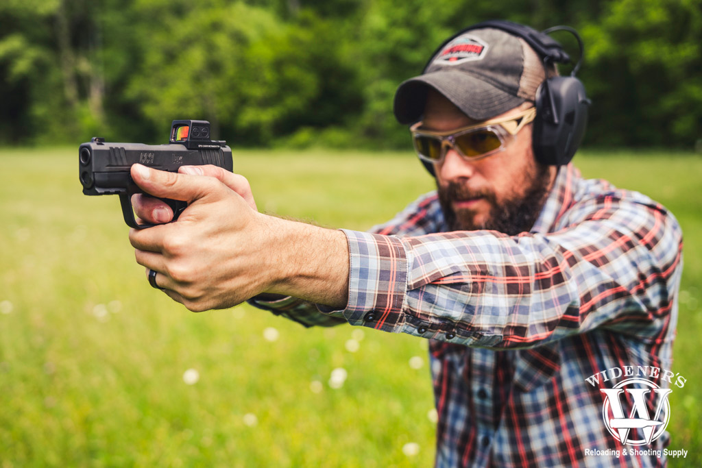 a photo of a man shooting a H&K cc9 subcompact pistol