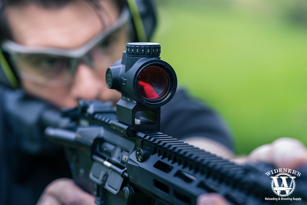 a photo of a rifle with a red dot sight