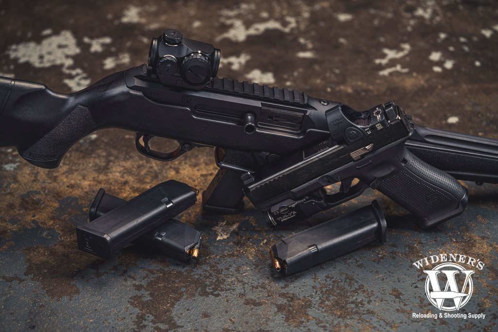 A photo comparing the ruger pc carbine VS glock handgun