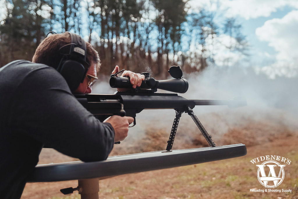 a photo of a man shooting a barrett bolt action rifle