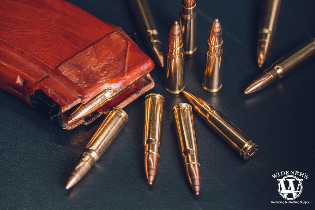 a photo of 7.62x39 ammo with a bakelite magazine