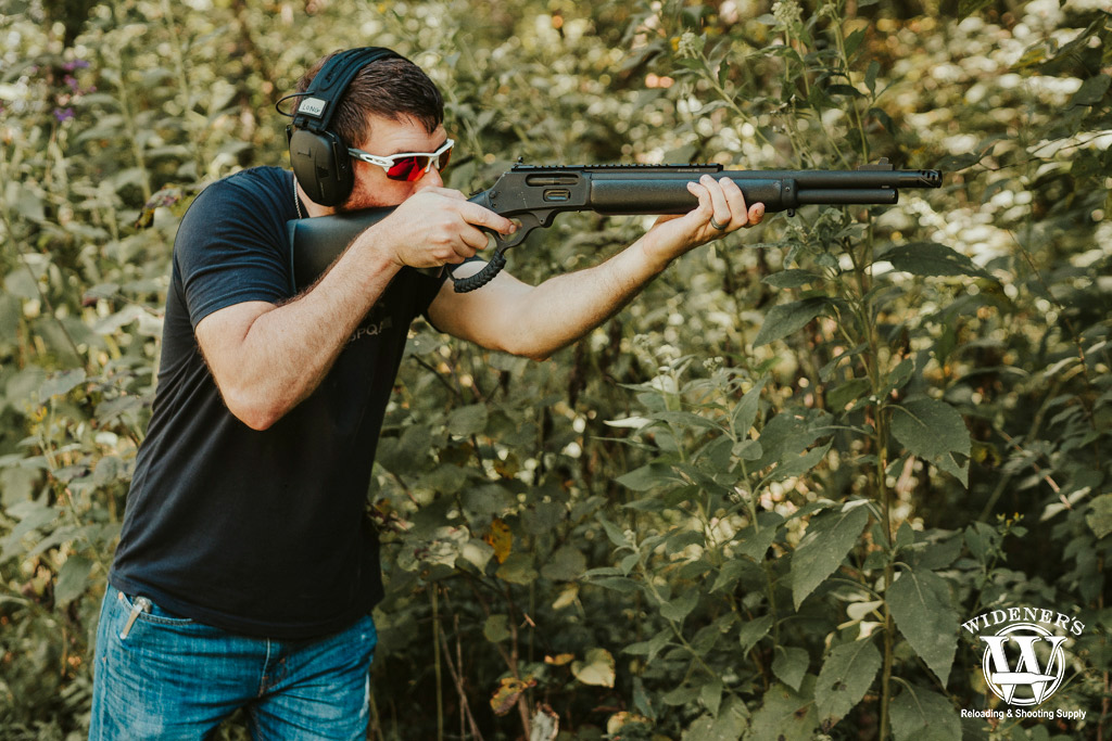 a photo of a man shooting a 45-70 lever action rifle