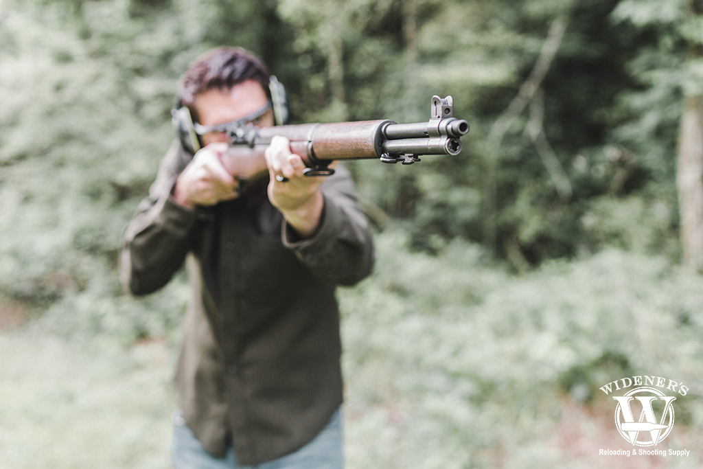a photo of a man shooting a rifle