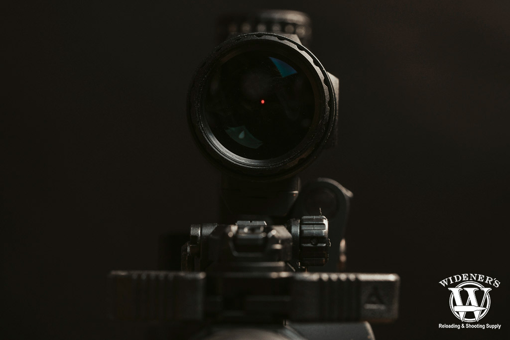 a photo looking through a red dot magnifier optic