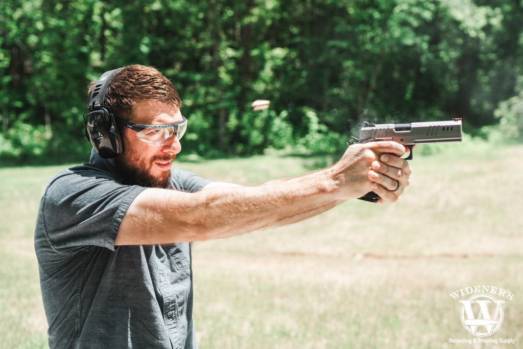 photo of a man shooting a nighthawk custom handgun