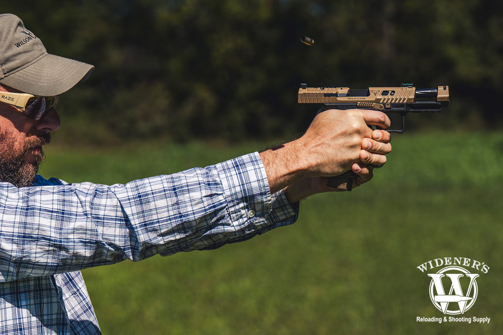 man shooting a handgun with a compensator a photo of a man shooting a handgun with a compensator