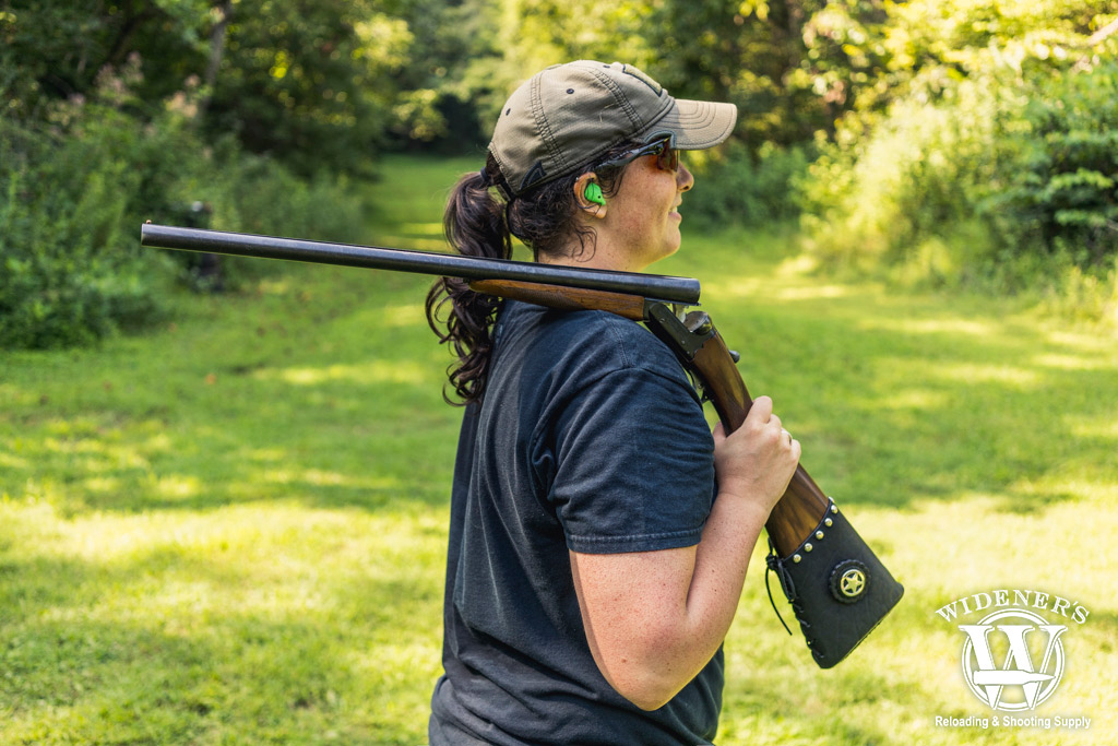 a photo of a female competition shooter with a side-by-side shotgun