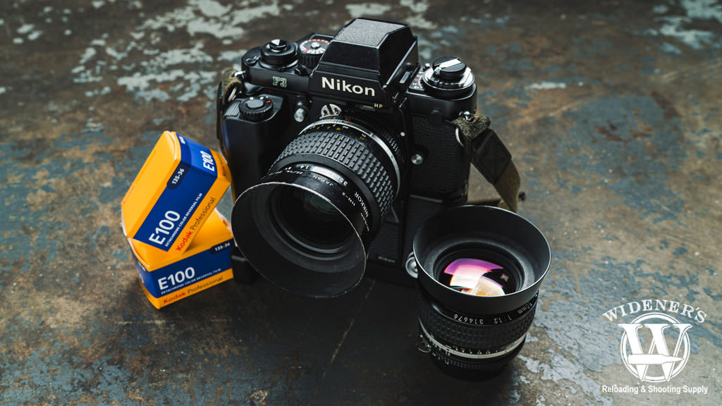 a photo of a nikon f3 HP camera with md-4 motor drive and mk-1 firing rate converter