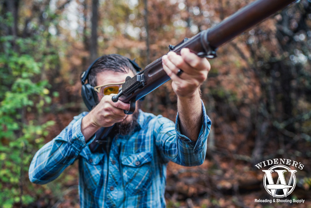 a photo of a man shooting a 1889 Krag-Jorgensen rifle