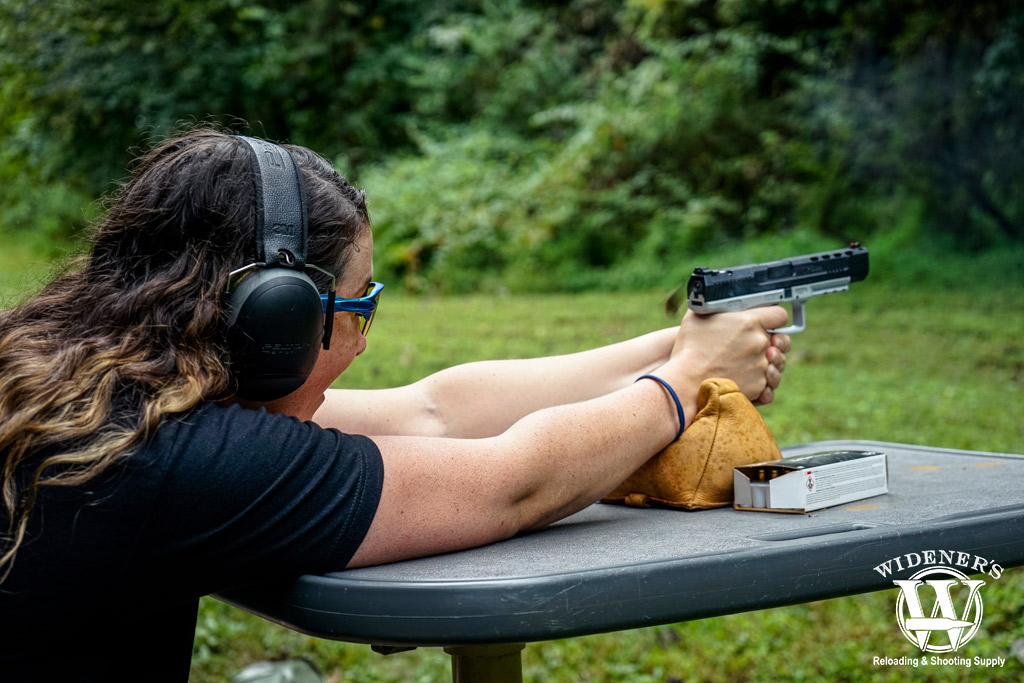 a photo of a woman shooting a 9mm handgun