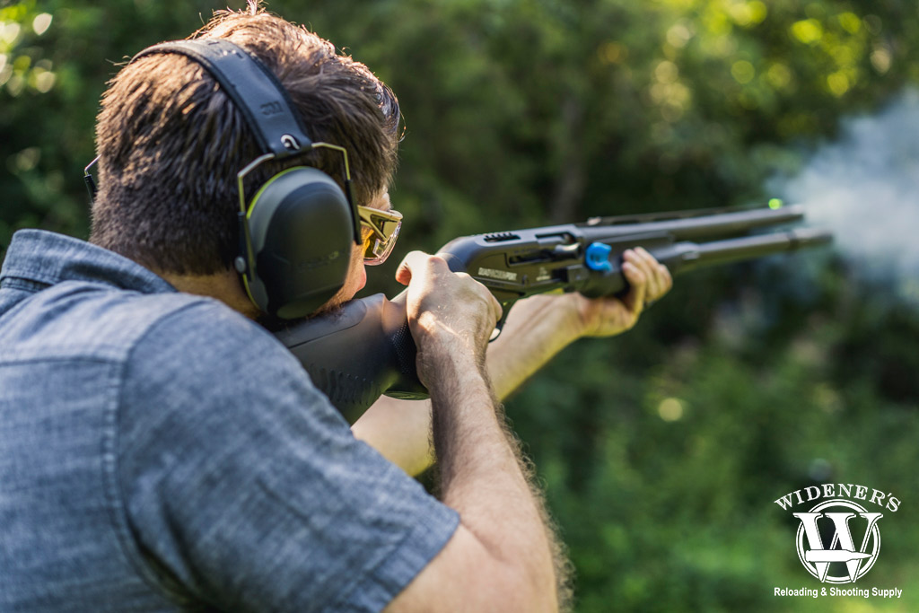 a photo of a man trapshooting with a semi-auto shotgun