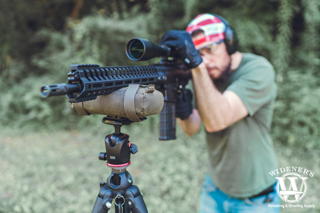 a photo of a an shooting an modern sporting rifle outdoors