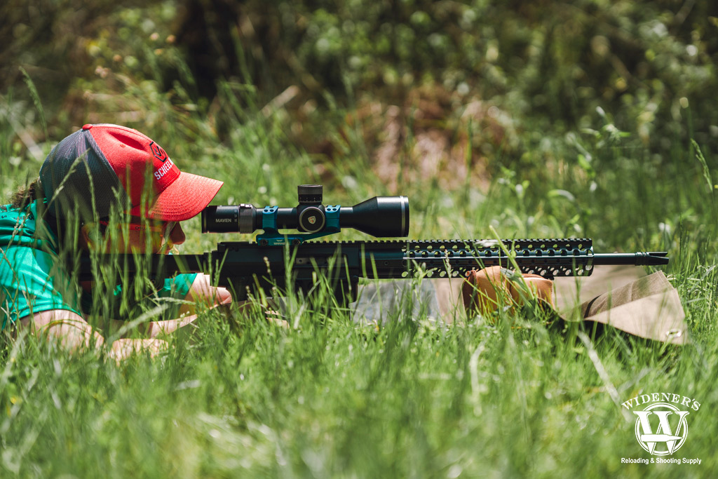 a photo of a female shooter in the prone position