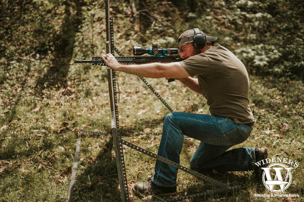 a photo of a man shooting an ar-10 rifle